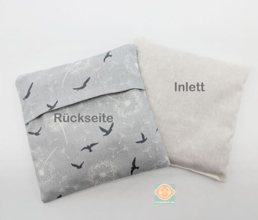 Kissenrückseite und Inlett mit Vogelmotiv.